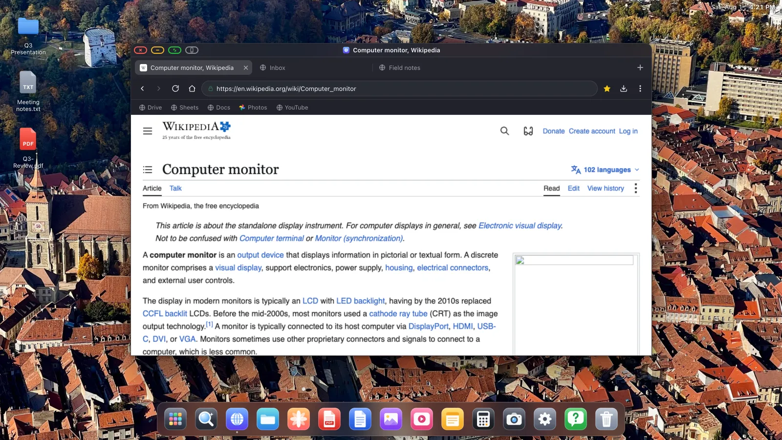 A desktop environment filling a 16:9 external display edge to edge, with a dock along the bottom.