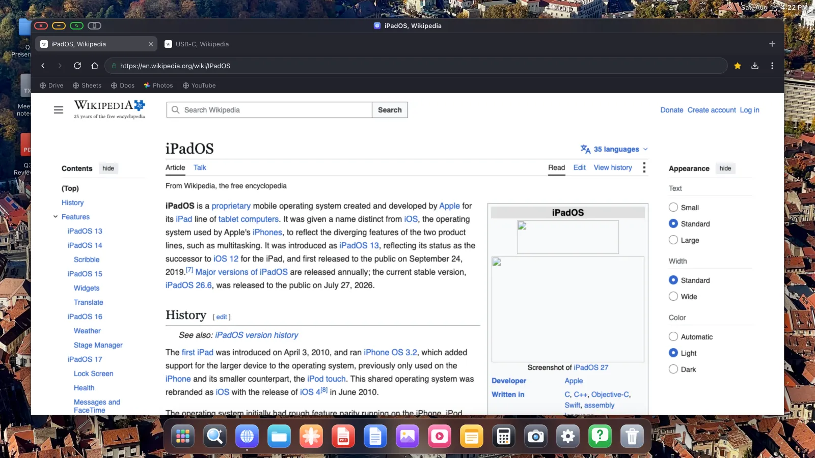 A real webpage about iPadOS open in a full-width browser window on an external display.