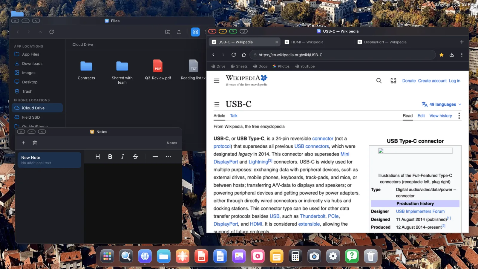 Three overlapping XeOS windows, Files browsing an iCloud Drive folder, Notes, and the browser, on one external display.