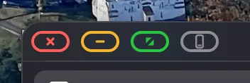 Close-up of a window's traffic-light buttons with an extra grey button beside them.